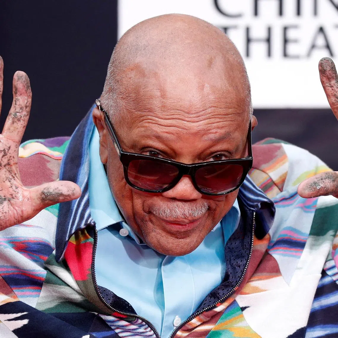 FILE PHOTO: Composer Quincy Jones shows his hands after placing them in cement during a ceremony in the forecourt of the TCL Chinese theatre in Los Angeles, California, U.S., November 27, 2018. REUTERS/Mario Anzuoni/File Photo