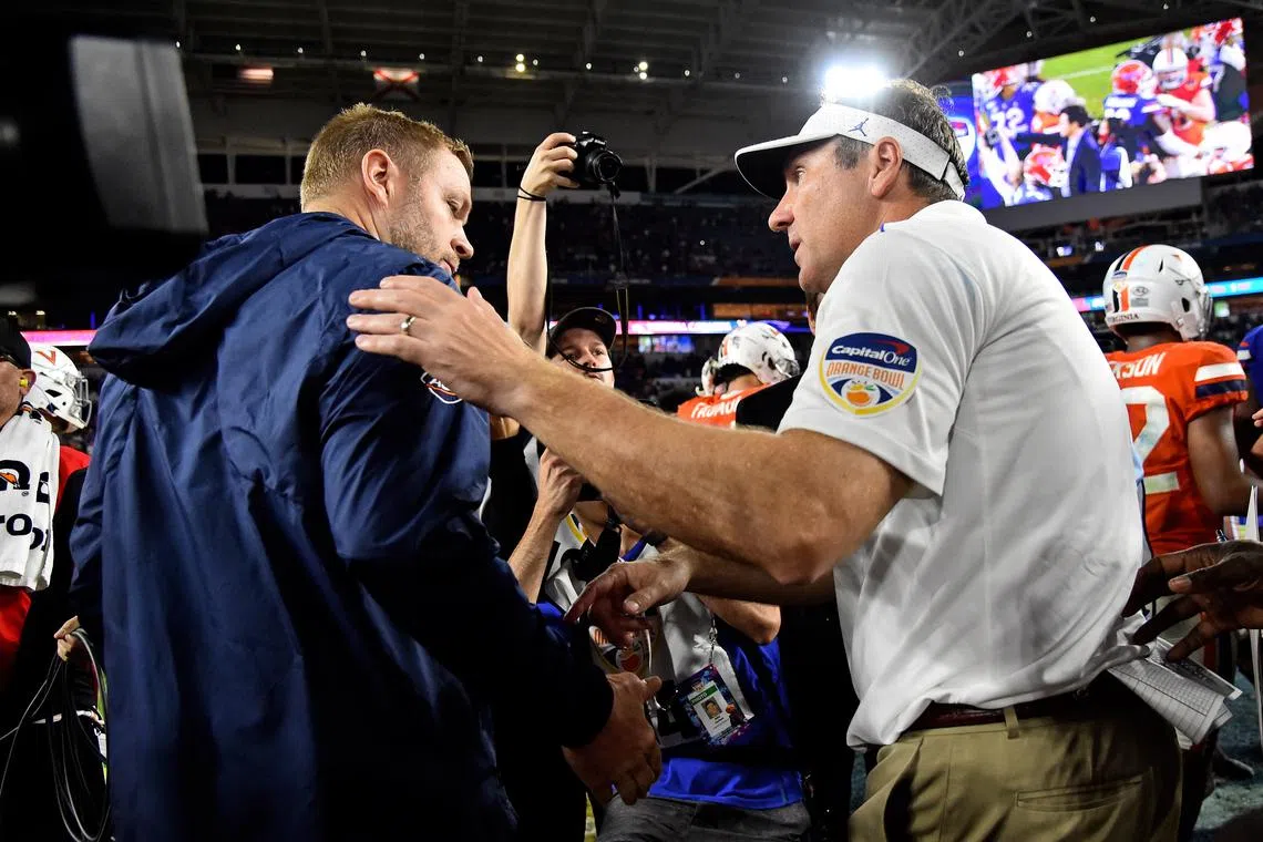 Dec 30, 2019; Miami Gardens, Florida, USA; Virginia Cavaliers head coach Bronco Mendenhall (L) shakes hands with Florida Gators head coach Dan Mullen (R) after the game at Hard Rock Stadium. Mandatory Credit: Jasen Vinlove-USA TODAY Sports/ File Photo