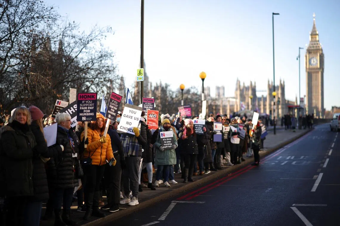 NHS nurses strike over pay outside St Thomas' Hospital in London on Dec 15. 