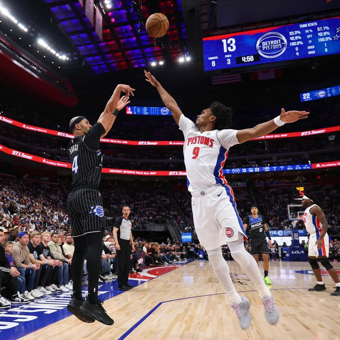 Jalen Suggs of the Orlando Magic takes a three-point shot over Ausar Thompson of the Detroit Pistons.