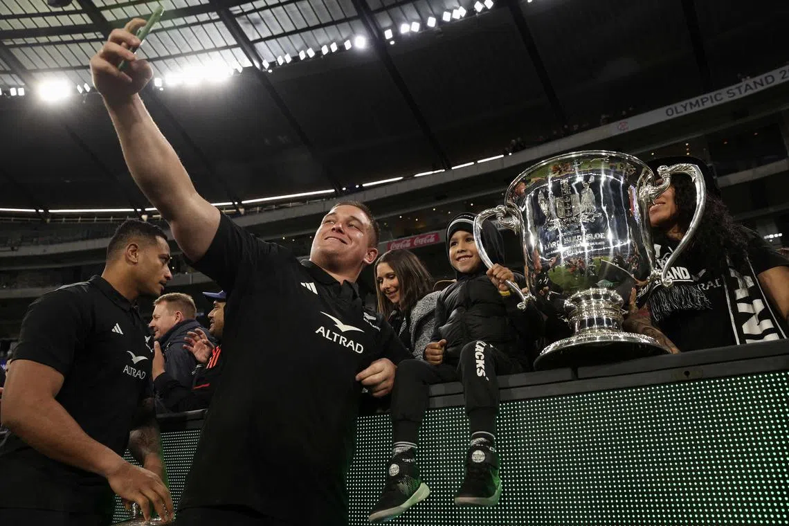 New Zealand's Ethan de Groot poses for a selfie with fans  during the Rugby Championship and 2023 Bledisloe Cup match between Australia and New Zealand at Melbourne Cricket Ground.