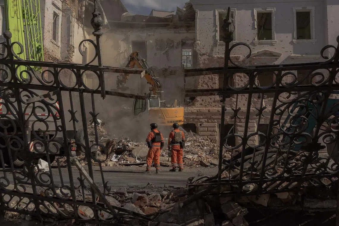 Ukrainian emergency workers searching through the rubble at the site of a missile attack in Sumy, northeastern Ukraine, on April 14, 2025, amid the Russian invasion of Ukraine. A Russian missile strike on April 13, 2025 on the Ukrainian city of Sumy killed at least 34 people, authorities said as European and US leaders condemned one of the deadliest attacks in months. Two ballistic missiles hit the centre of the northeastern city, close to the Russian border, Ukrainian authorities said. 