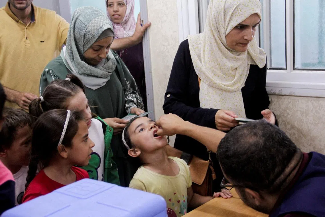FILE PHOTO: A Palestinian child is vaccinated against polio, amid the Israel-Hamas conflict, in Jabalia in northern Gaza Strip, September 10, 2024. REUTERS/Mahmoud Issa/File Photo