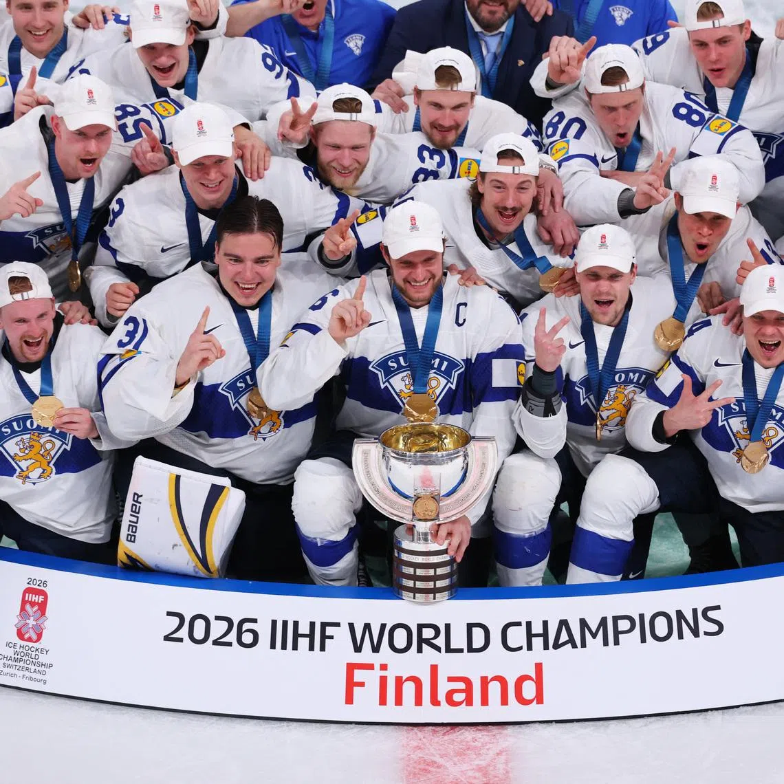 Ice Hockey - IIHF World Championships - Gold Medal Game - Switzerland v Finland - Swiss Life Arena, Zurich, Switzerland - May 31, 2026 Finland's Aleksander Barkov and teammates pose for a photo with the trophy after winning gold REUTERS/Denis Balibouse