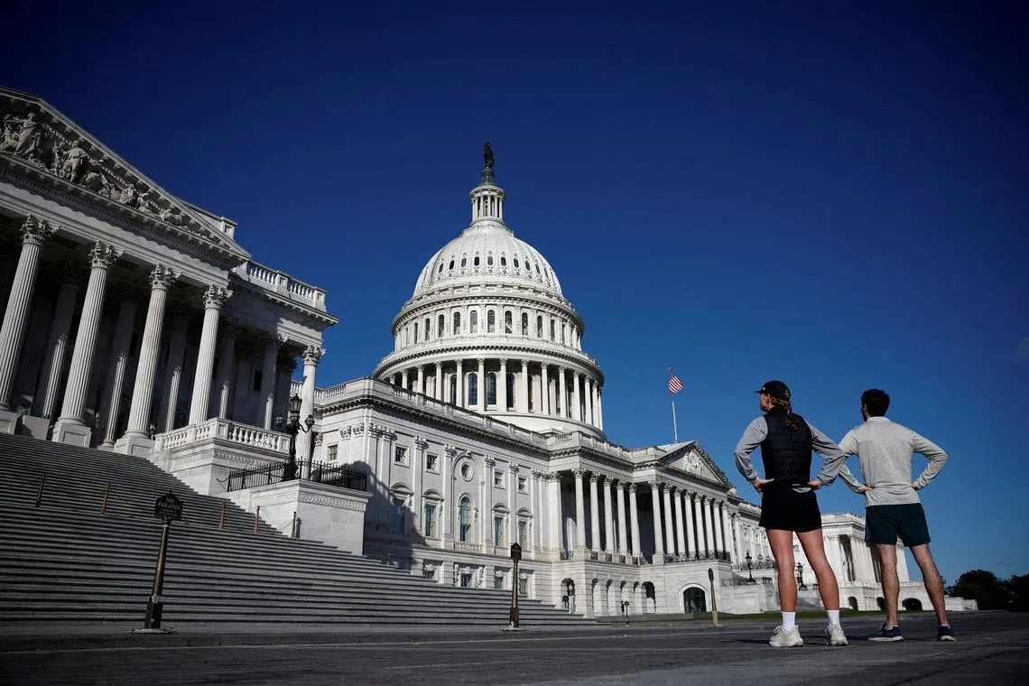 FILE PHOTO: People look the U.S. Capitol on Capitol Hill in Washington, U.S., November 23, 2024. REUTERS/Benoit Tessier/File Photo