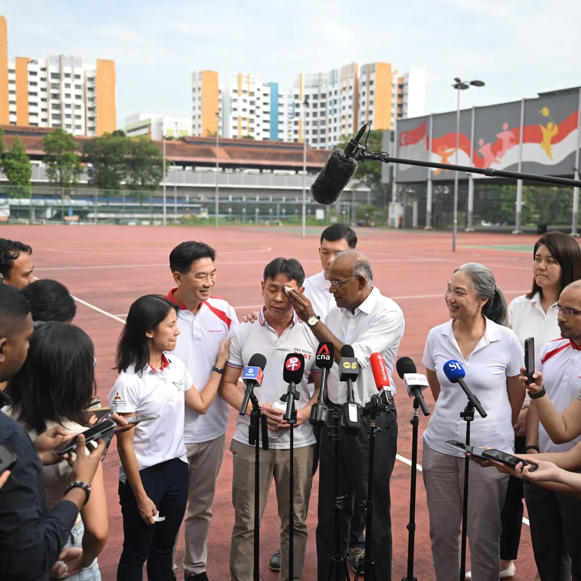 Law and Home Affairs Minister K. Shanmugam wiping tears off Mr Louis Ng’s face at a doorstop on April 22.