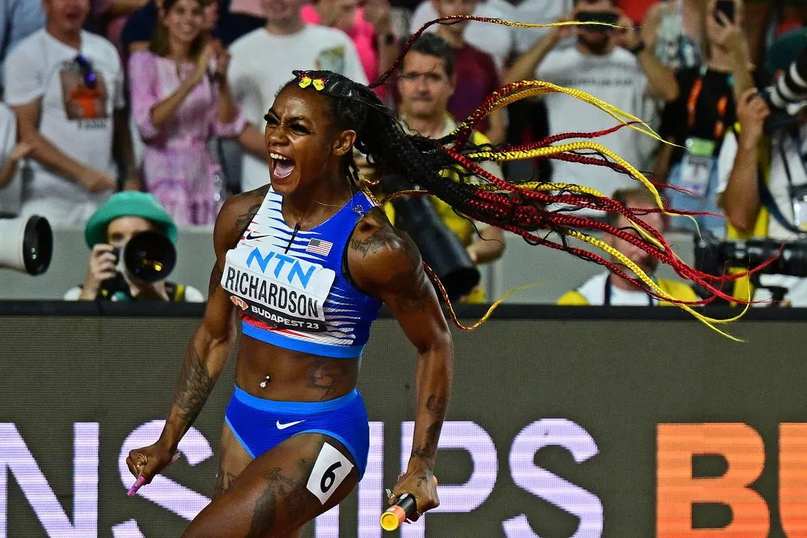 USA's Sha'Carri Richardson celebrates as she crosses the line to anchor the USA team to victory in the women's 4x100m relay final.