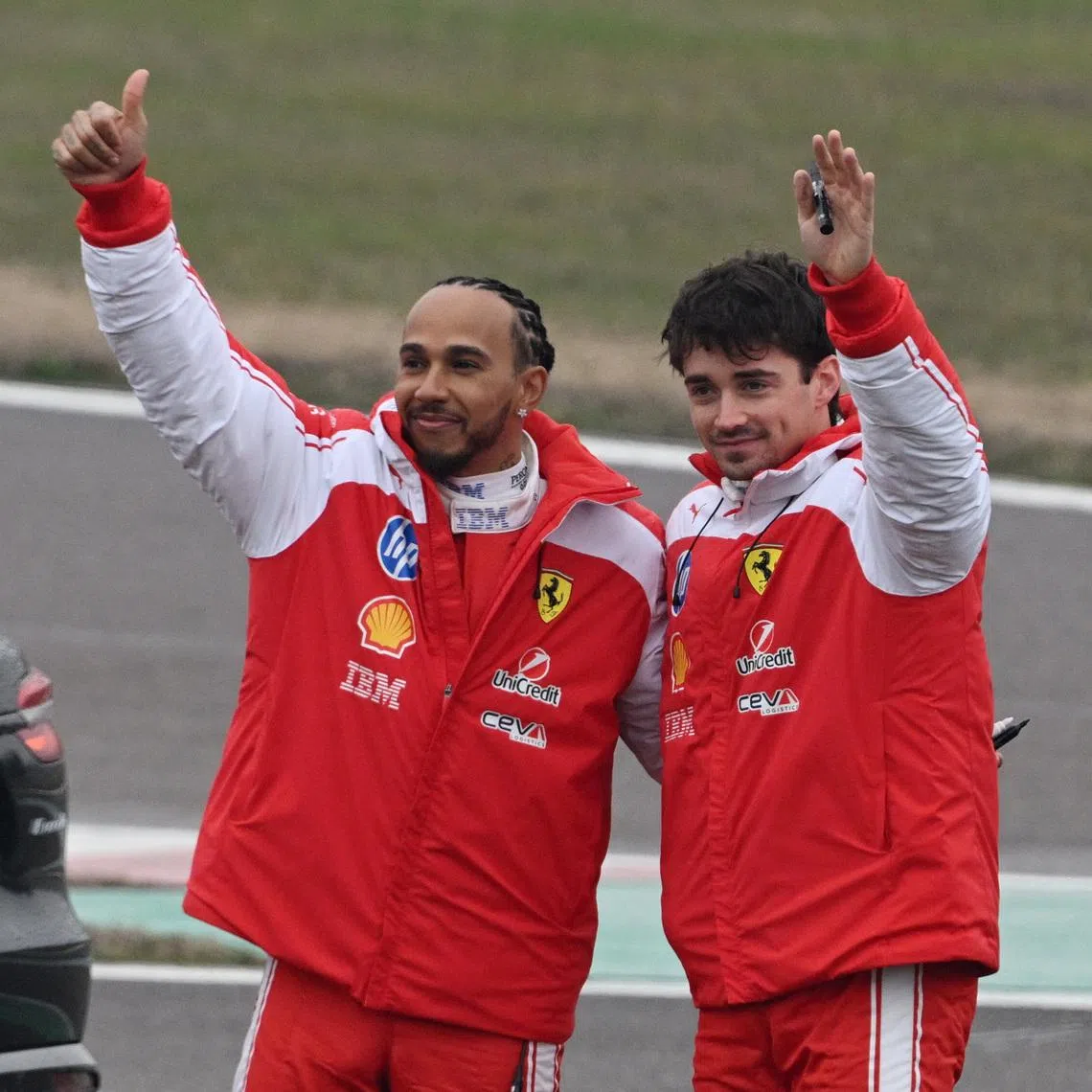 Formula One F1 - Ferrari's Lewis Hamilton and Ferrari's Charles Leclerc drive Ferrari's new Formula 1 car the SF-26 during testing - Fiorano Circuit, Maranello, Italy - January 23, 2026 Ferrari's Lewis Hamilton and Charles Leclerc wave to fans during testing. REUTERS/Jennifer Lorenzini