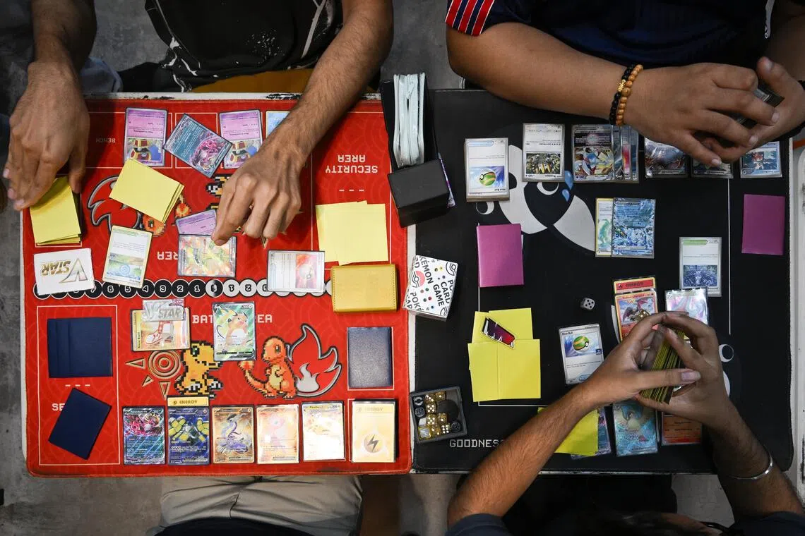 Pokémon card collectors and players playing Pokémon cards.