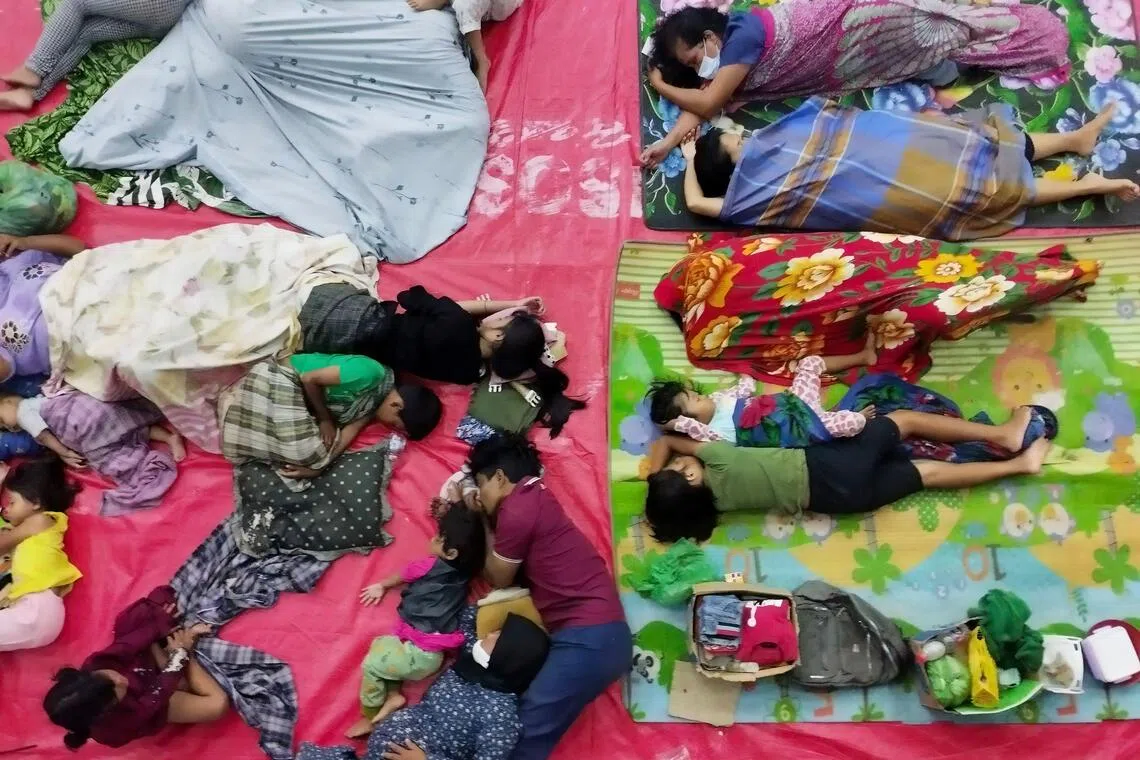 Flood-affected residents rest at an evacuation shelter in Central Tapanuli, North Sumatra.