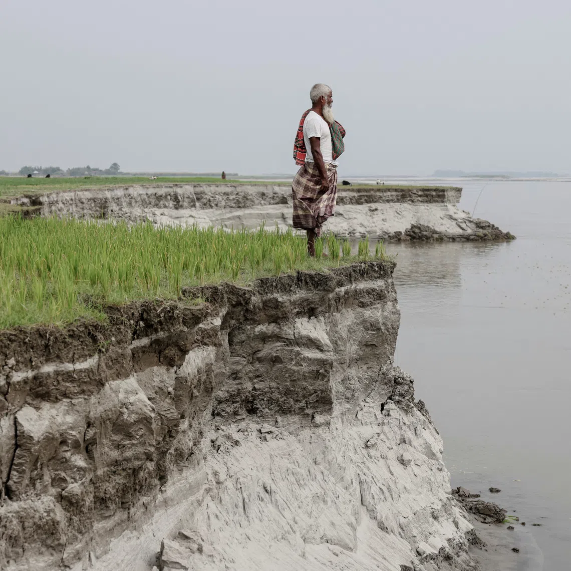Every year, hundreds of families in Kurigram, Bangladesh, are faced with collapsed riverbanks and constant relocating.

Kosim Uddin, 50, looks toward the site of his vanished home as he poses for a picture on an island in the Brahmaputra River, where he recently relocated due to erosion, in Kurigram, Bangladesh, October 29, 2025. REUTERS/Mohammad Ponir Hossain