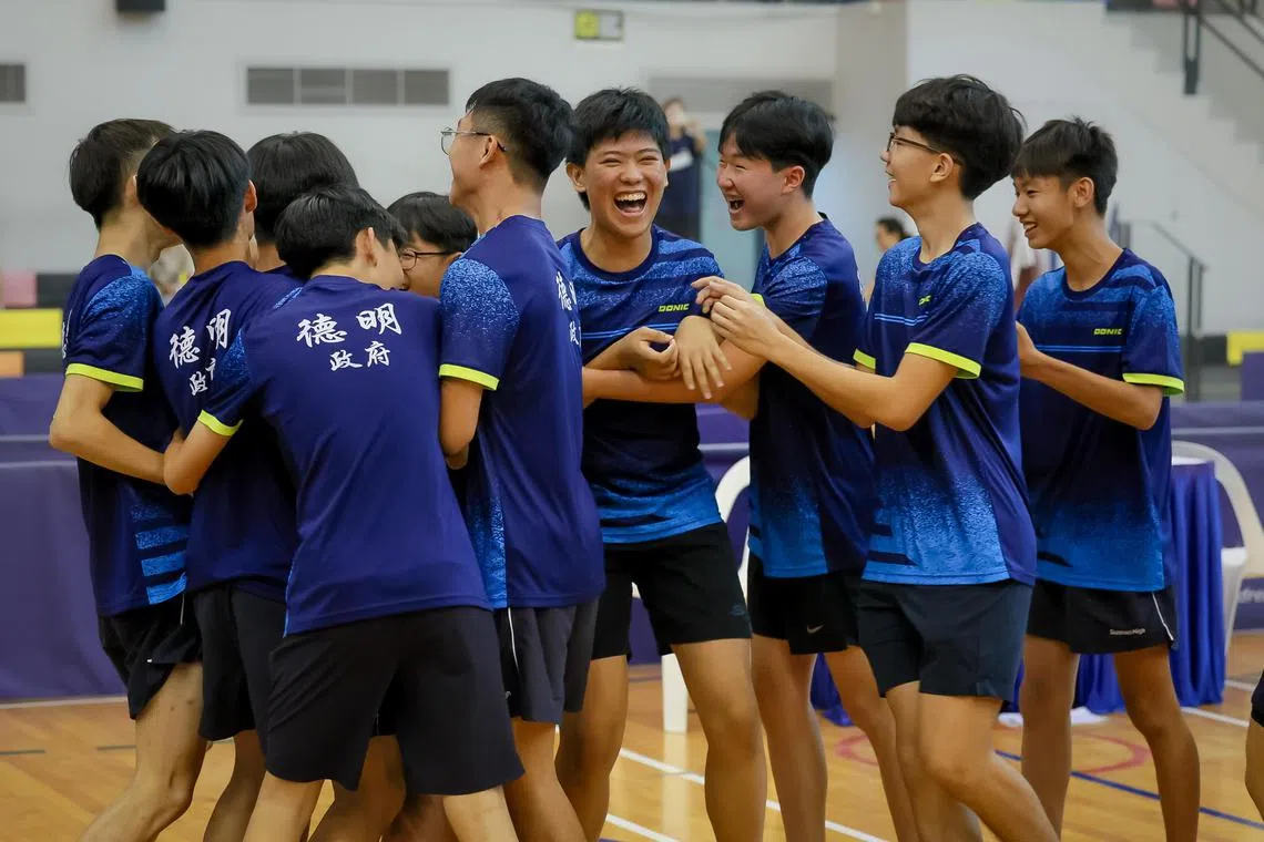 Players from Dunman High School celebrate after winning the B Division boys’ table tennis final against Raffles Institution at Pasir Ris Sports Hall on April 3, 2024.