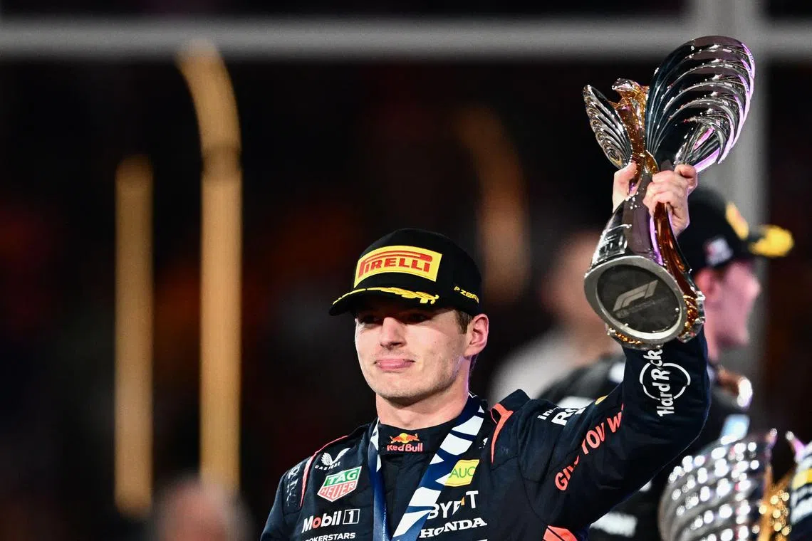 Red Bull Racing's Dutch driver Max Verstappen celebrateing with the trophy on the podium after winning the Abu Dhabi Formula One Grand Prix at the Yas Marina Circuit in the Emirati city on Nov 26.