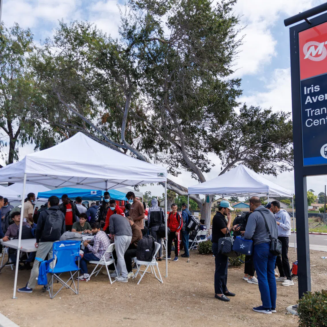 Migrants, who crossed the U.S.-Mexico border and were detained and released by U.S. Customs and Border Protection, gather at a transit station as they plan to travel across the country from the San Ysidro neighborhood of San Diego, California, U.S., September 20, 2023. REUTERS/Mike Blake