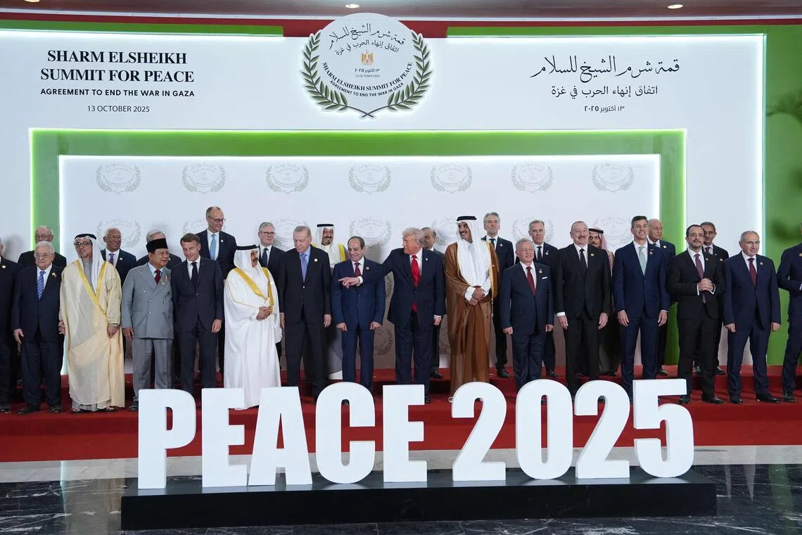 US President Donald Trump (centre) poses for a picture with world leaders during a summit on Gaza in Sharm el-Sheikh on Oct 13, 2025. 