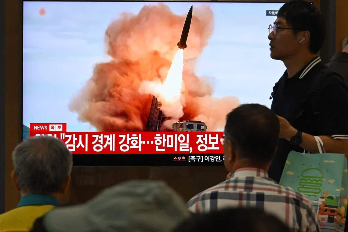People watching a news broadcast with file footage of a North Korean missile test, at a train station in Seoul on Aug 20.