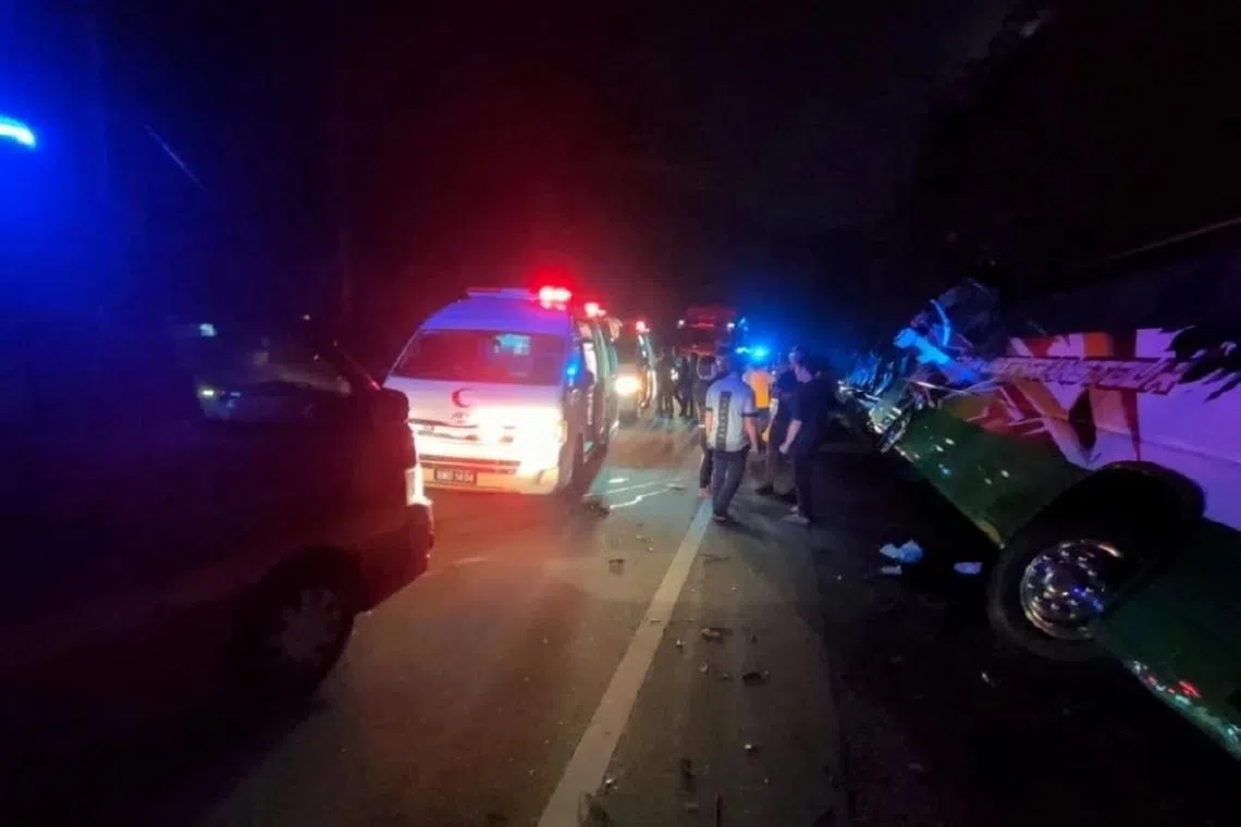 Photos of the aftermath show an overturned bus and passengers standing on the side of the road waiting for rescue.