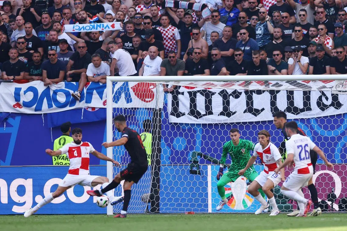 Albania's Klaus Gjasula scores the second goal in the 2-2 draw with Croatia.