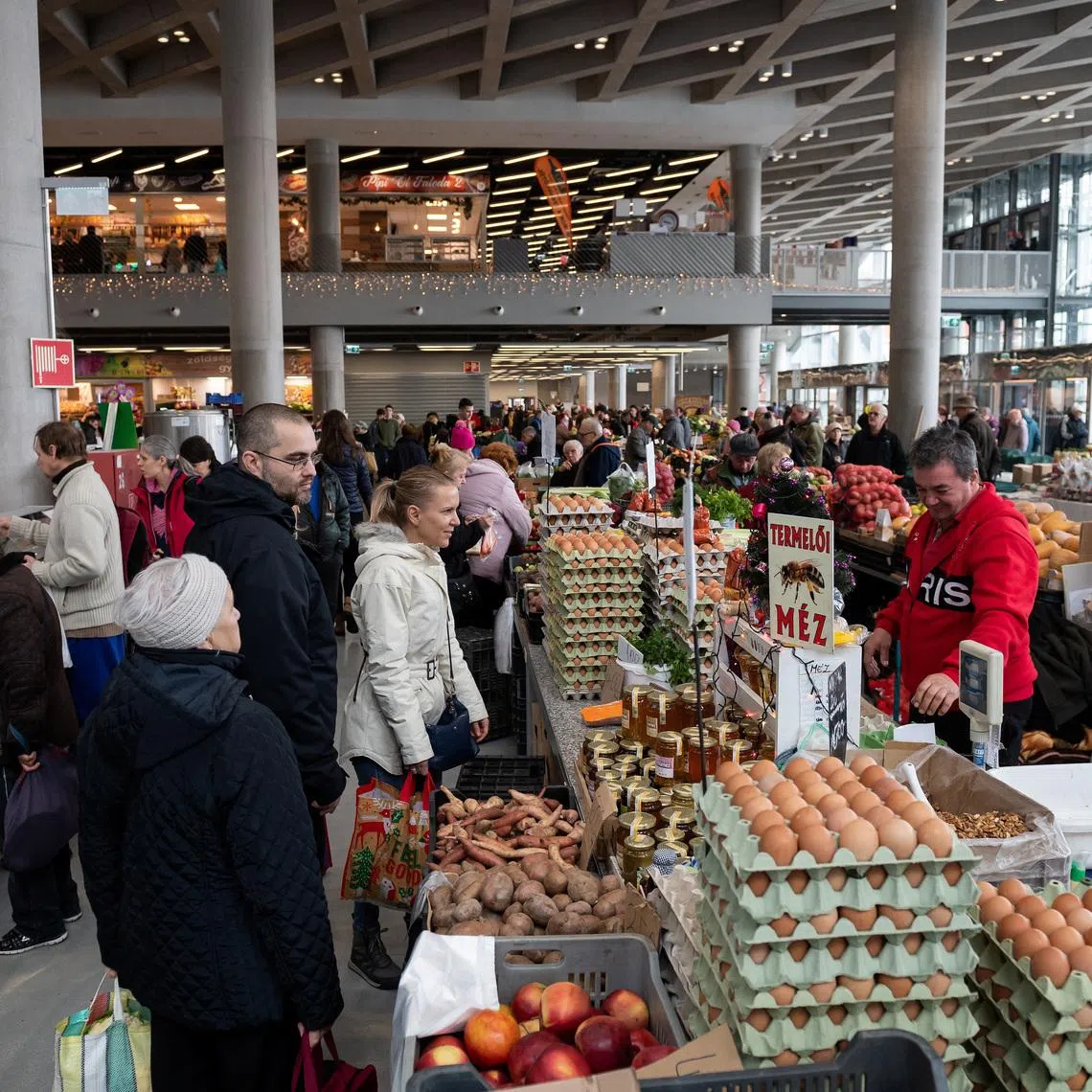 People buy food at a market in Budapest, Hungary, December 3, 2022. REUTERS/Marton Monus