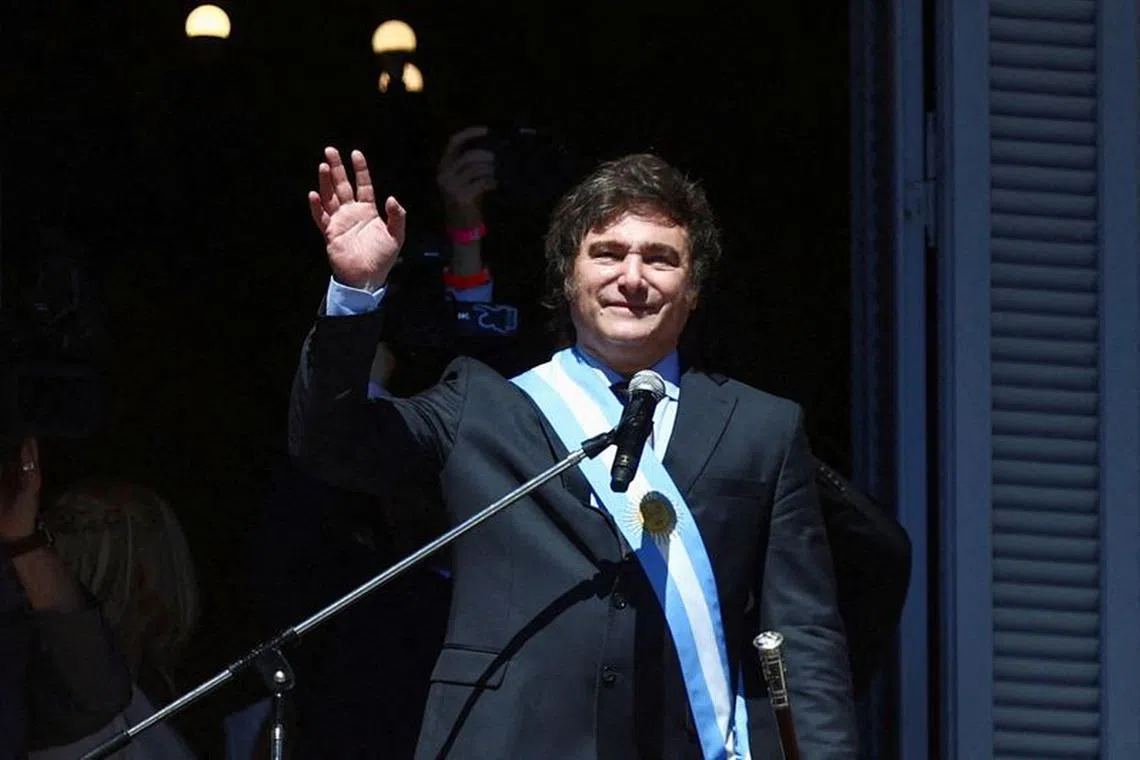 FILE PHOTO: Argentina's President Javier Milei waves to supporters gathered outside Casa Rosada after his swearing-in ceremony, in Buenos Aires, Argentina December 10, 2023. REUTERS/Matias Baglietto