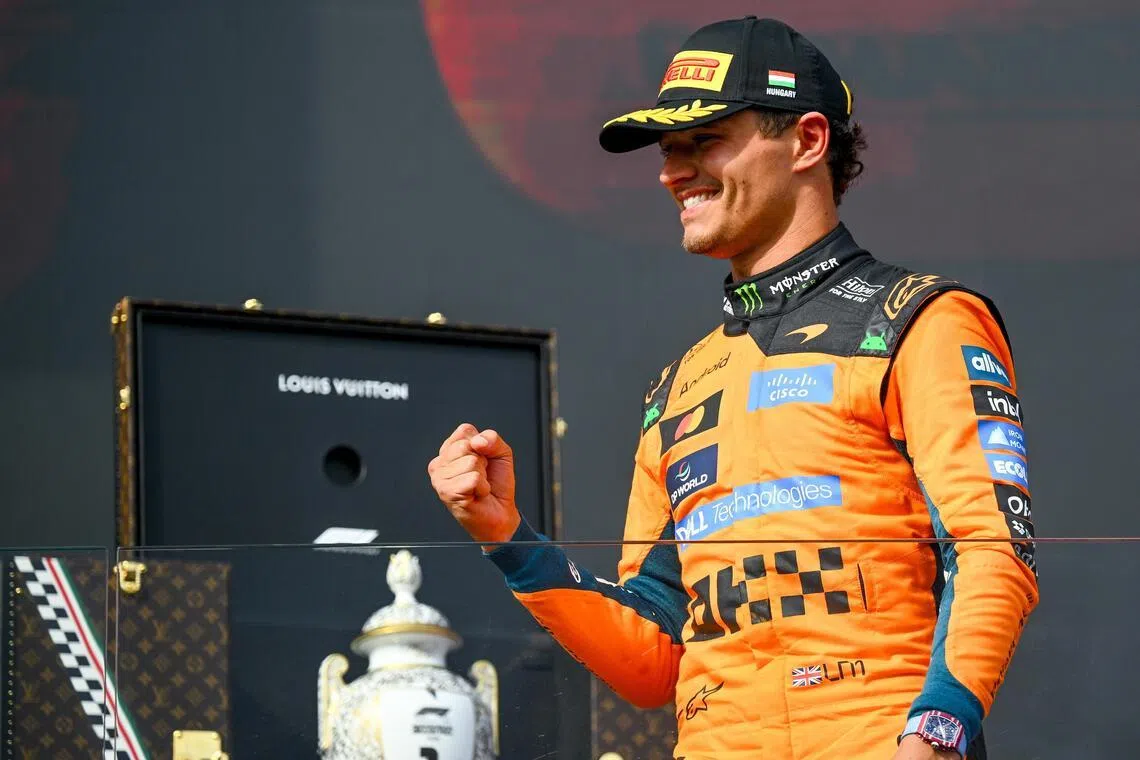McLaren driver Lando Norris of Britain celebrates his win on the podium after the Formula One Hungarian Grand Prix on July 26.