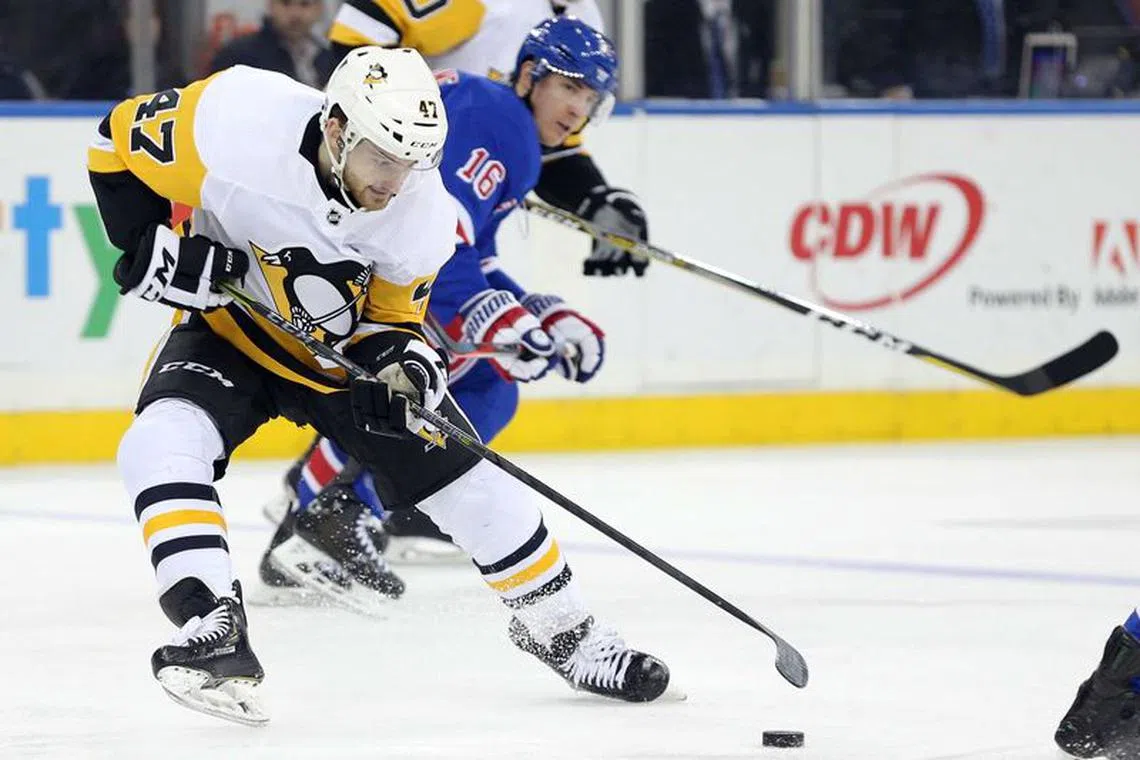 Mar 25, 2019; New York, NY, USA; Pittsburgh Penguins center Adam Johnson (47) plays the puck against New York Rangers center Ryan Strome (16) during the third period at Madison Square Garden. Brad Penner-USA TODAY Sports/File Photo