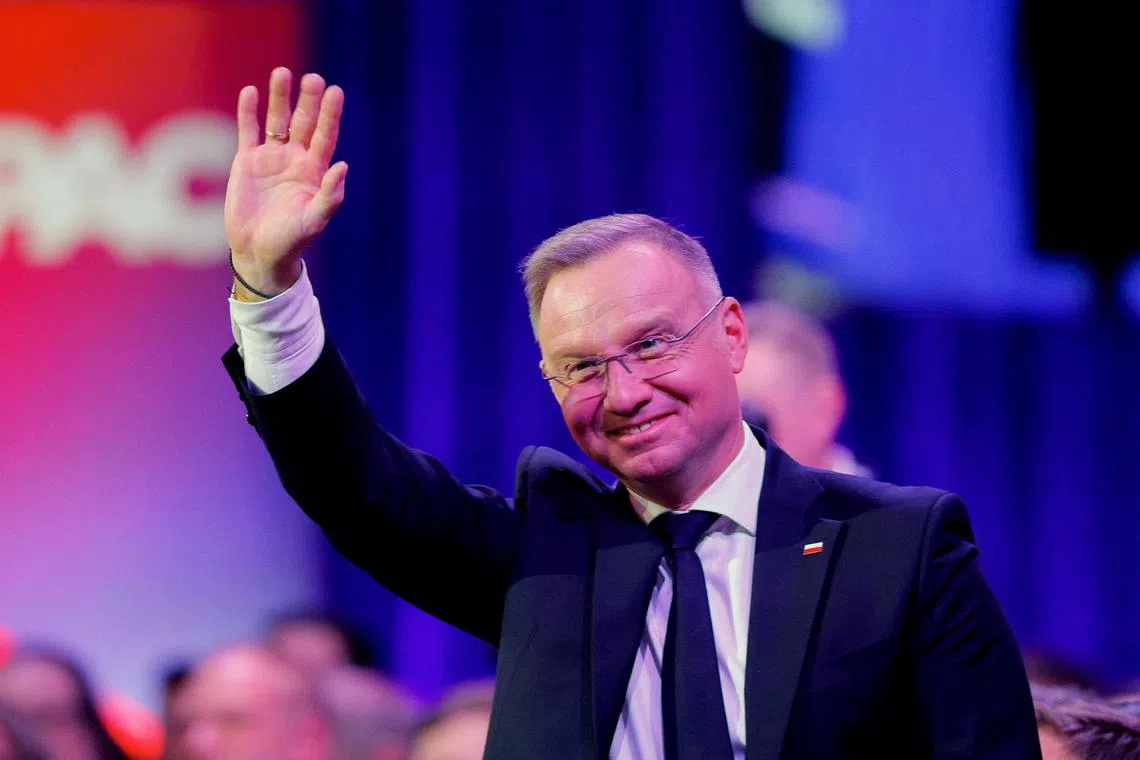 Polish President Andrzej Duda waves at the Conservative Political Action Conference (CPAC) annual meeting in National Harbor, Maryland, U.S., February 22, 2025. REUTERS/Brian Snyder