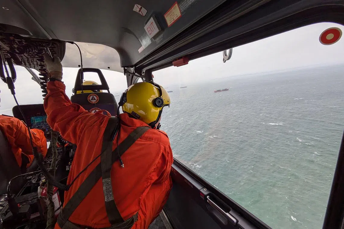 Philippine coast guard personnel survey parts of Manila Bay after an oil tanker carrying 1,494 tonnes of fuel capsized in seas north of Manila.
