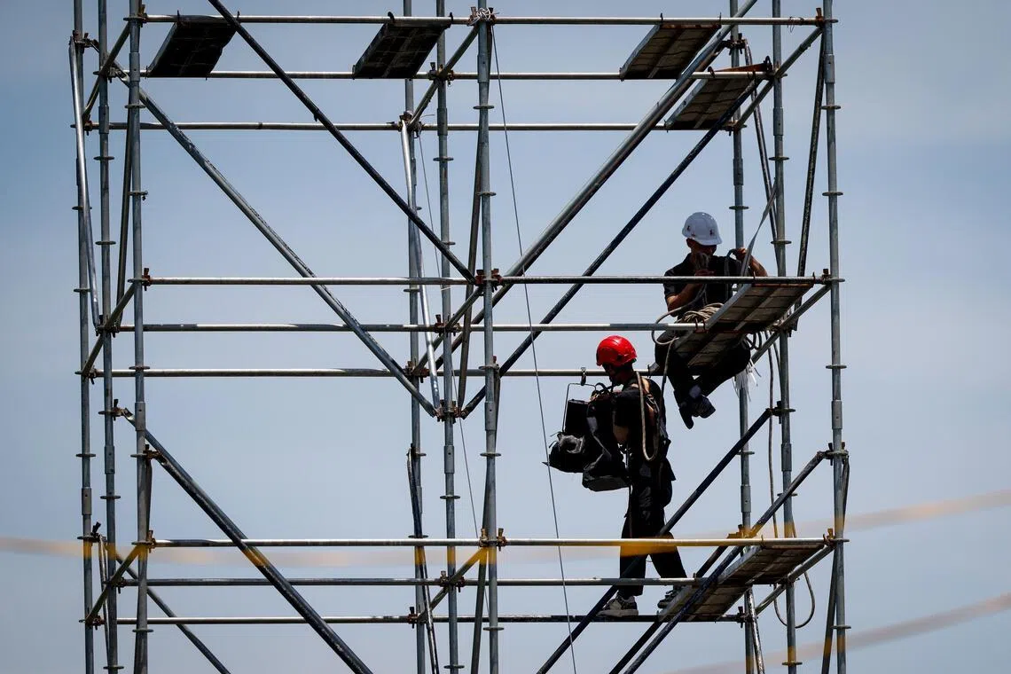 Labourers working under scorching heat in Hanoi, Vietnam, on June 23.