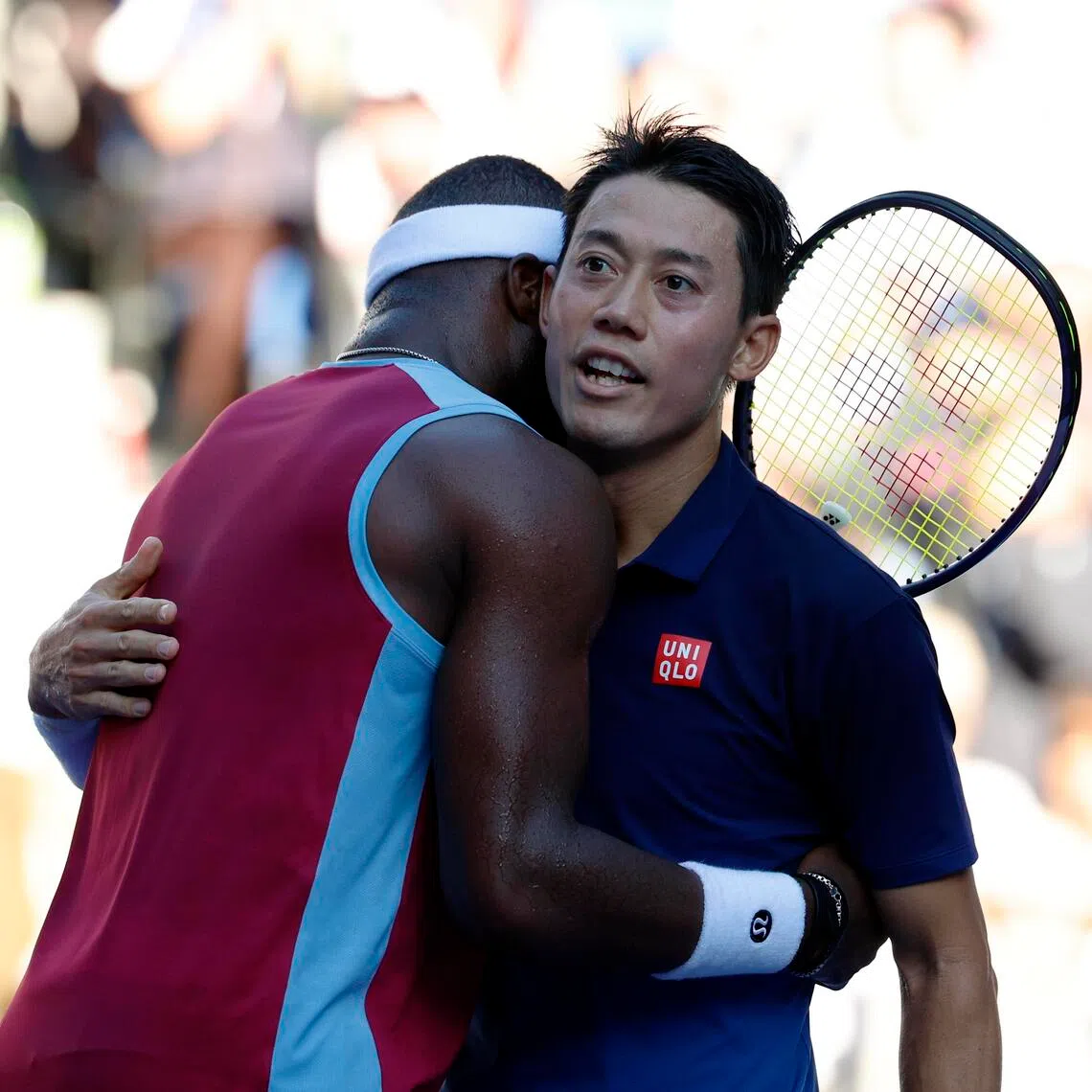 Kei Nishikori of Japan and Frances Tiafoe of the US hug after their round-of-32 match at the Japan Open on Oct 1.