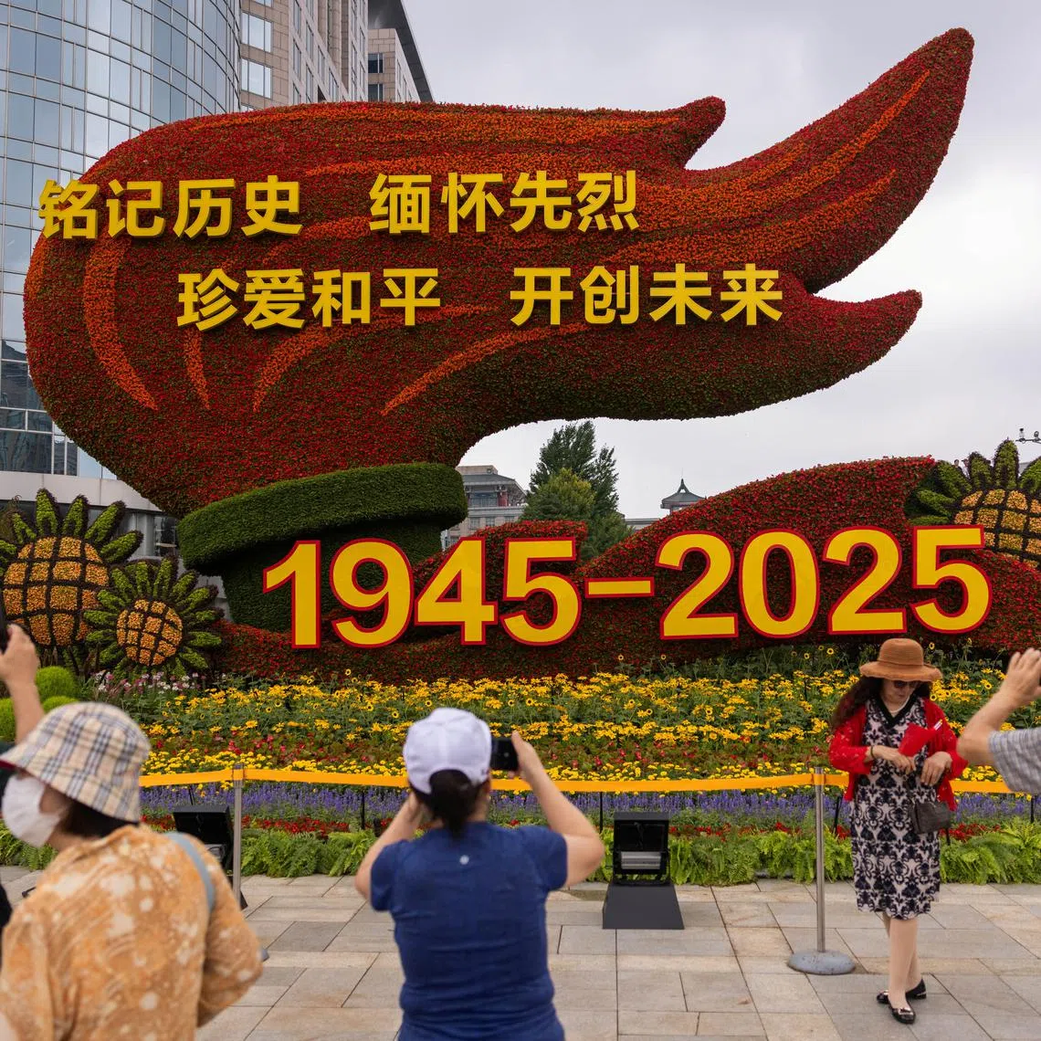 People take images of a flower installation commemorating the 80th anniversary of the end of World War Two, in Beijing, China, August 18, 2025. REUTERS/Maxim Shemetov