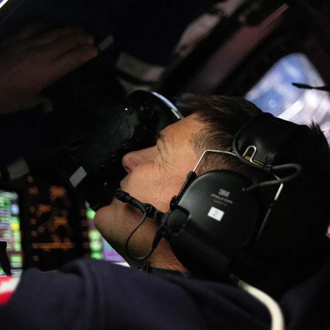 Canadian Space Agency (CSA) astronaut and Artemis II Mission Specialist Jeremy Hansen takes photographs through the Orion spacecraft's window during the Artemis II crew’s flyby of the Moon April 6, 2026.  Picture released April 7, 2026.      NASA/Handout via REUTERS