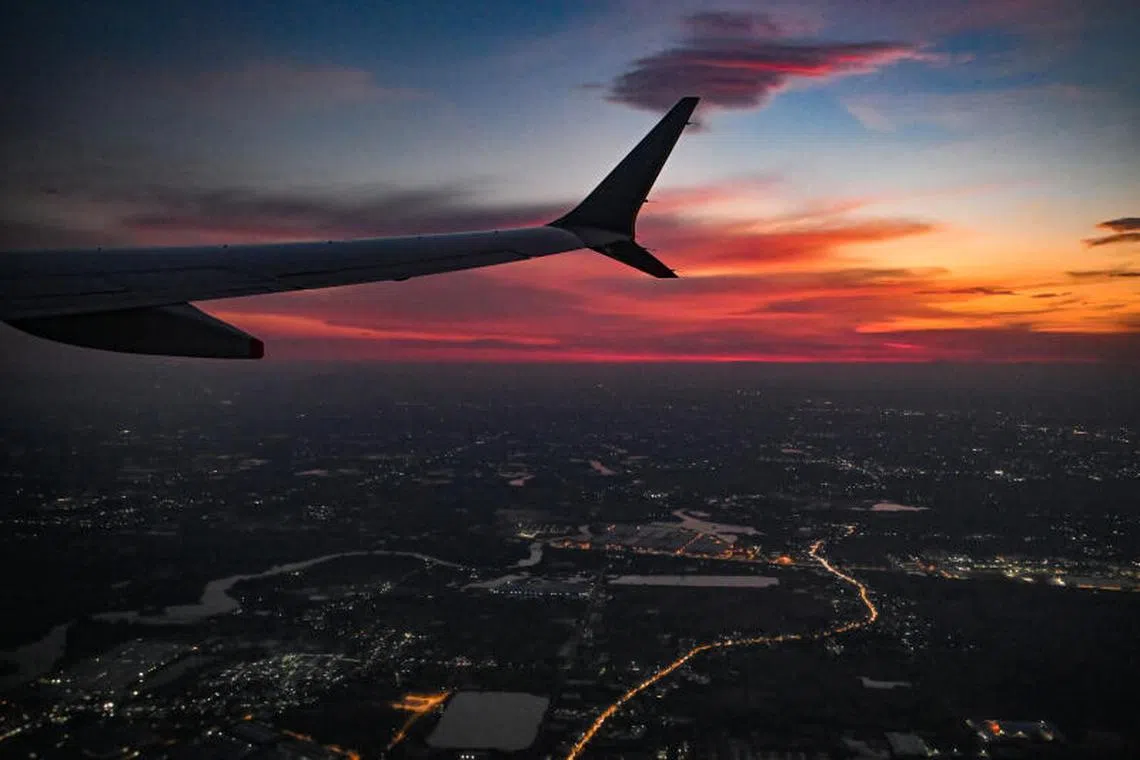 A plane take-off over Phnom Penh, Cambodia with a sunset in the background, 18 May 2023. travel, tourist, carrier, commercial, airline, plane, aviation, airport, fuel, travel, business