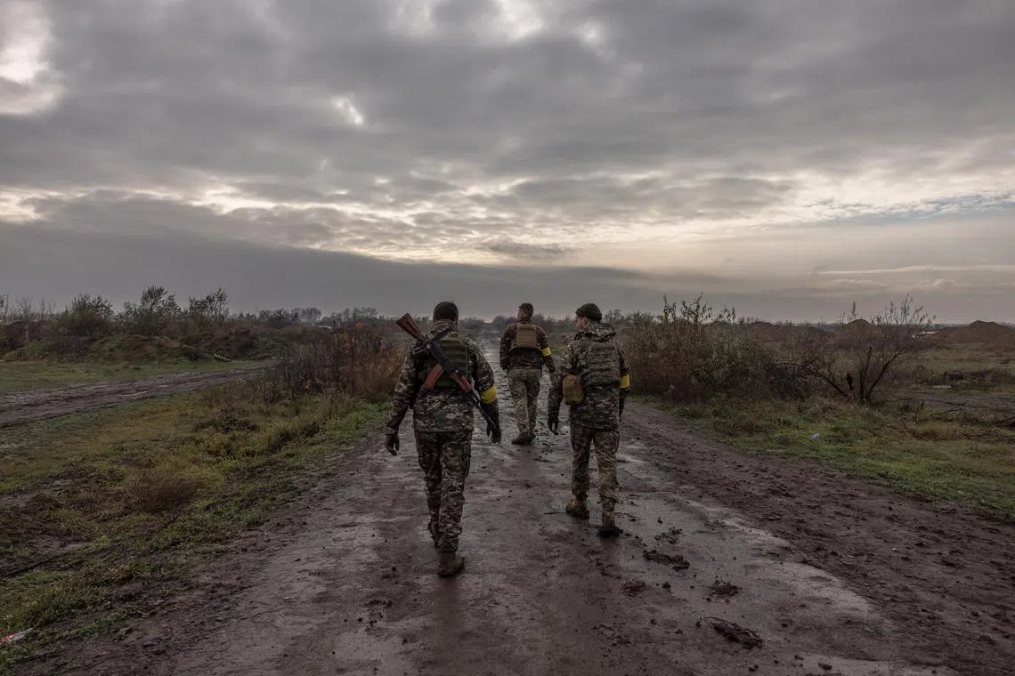 Ukrainian soldiers check the area after Russian troops retreated from Kherson, on Nov 24, 2022.