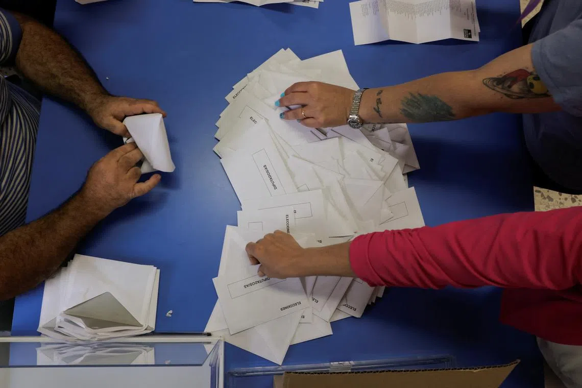 Polling station staff members count ballots, during the European Parliament election, in Ronda, Spain, June 9, 2024. REUTERS/Jon Nazca