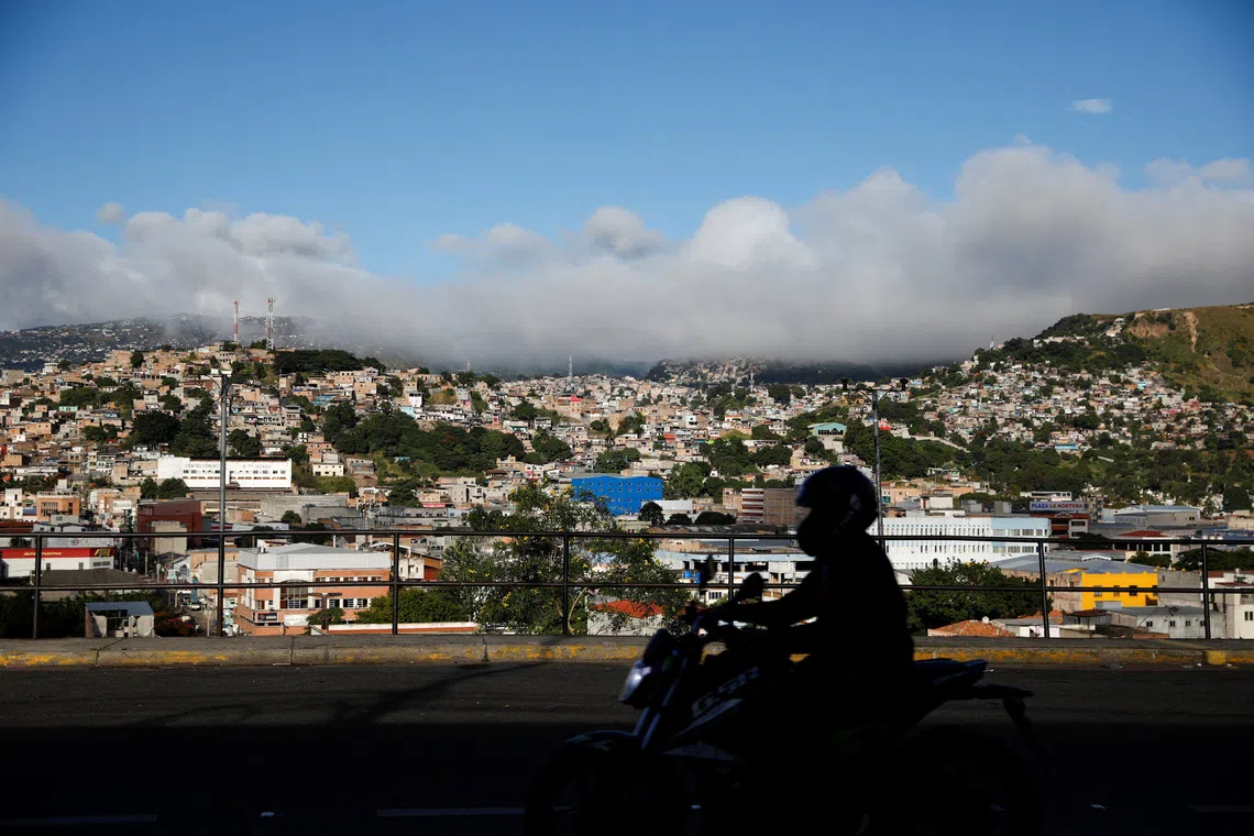 A motorcyclist rides in a street after the general election, in Tegucigalpa, Honduras, December 1, 2025. REUTERS/Jose Cabezas
