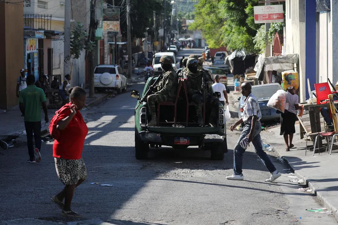 Members of the Haitian Armed Forces patrol the area as people flee homes following the armed gangs violence over the weekend, many grouped behind an alliance known as Viv Ansanm, at the Poste Marchand suburb, in Port-au-Prince, Haiti December 9, 2024. REUTERS/Ralph Tedy Erol/File photo