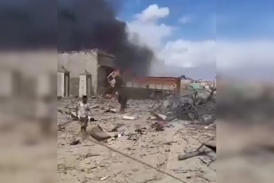 A truck packed with explosives killed at least 13 people and wounded dozens more, as nearby buildings were razed to the ground.