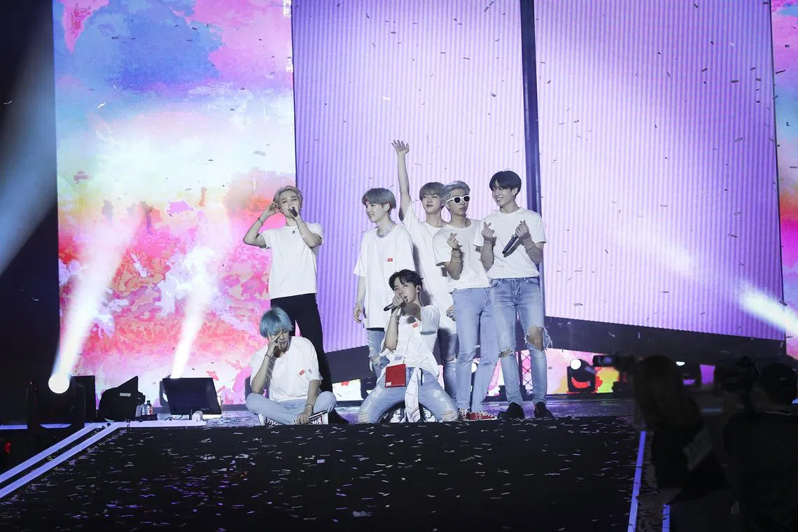 South Korean boyband BTS, which comprise (from far left) Jungkook, Jimin, Jin, V, RM, Suga and J-Hope, performing on stage.