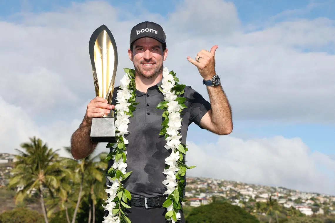  Nick Taylor of Canada poses with the trophy after defeating Nico Echavarria of Colombia in a play-off to win the Sony Open in Hawaii.