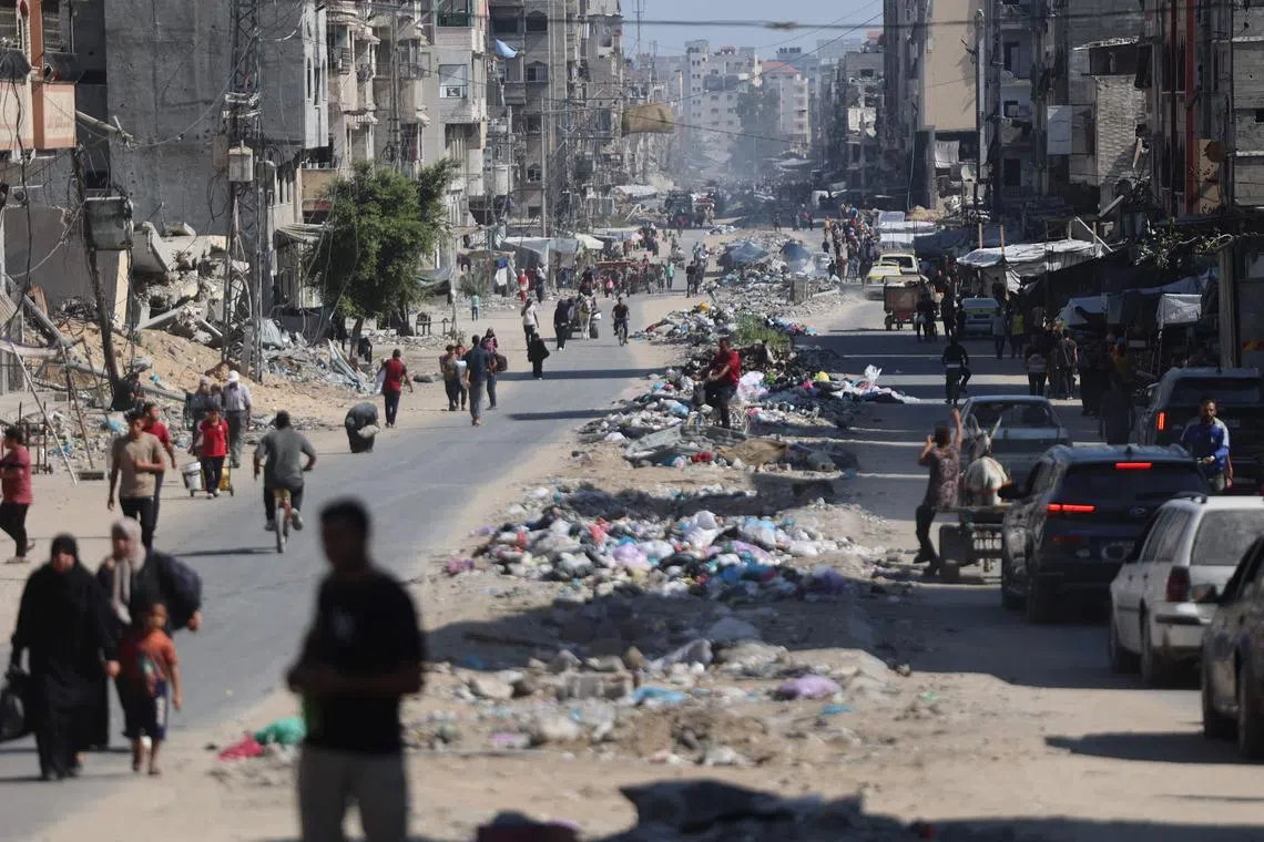 Palestinians carry their belongings as they flee areas north of Gaza City in the northern Gaza Strip.