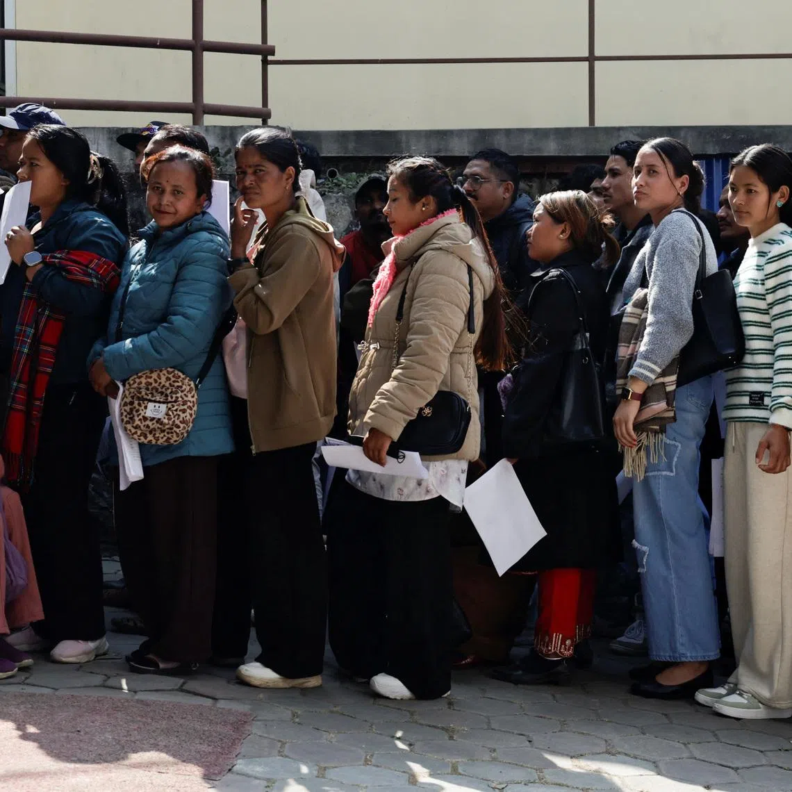 People planning to leave the country and apply for foreign employment in search of better opportunities queue as they prepare for an interview at Motherland Overseas, a recruitment agency, as Nepal's biggest political parties vow to fix the outflow of workers ahead of the elections of the House of Representatives scheduled for March 5, triggered by historic youth-led protests fuelled by the lack of jobs and endemic corruption that forced an elected prime minister to resign, in Kathmandu, Nepal, February 22, 2026. REUTERS/Navesh Chitrakar