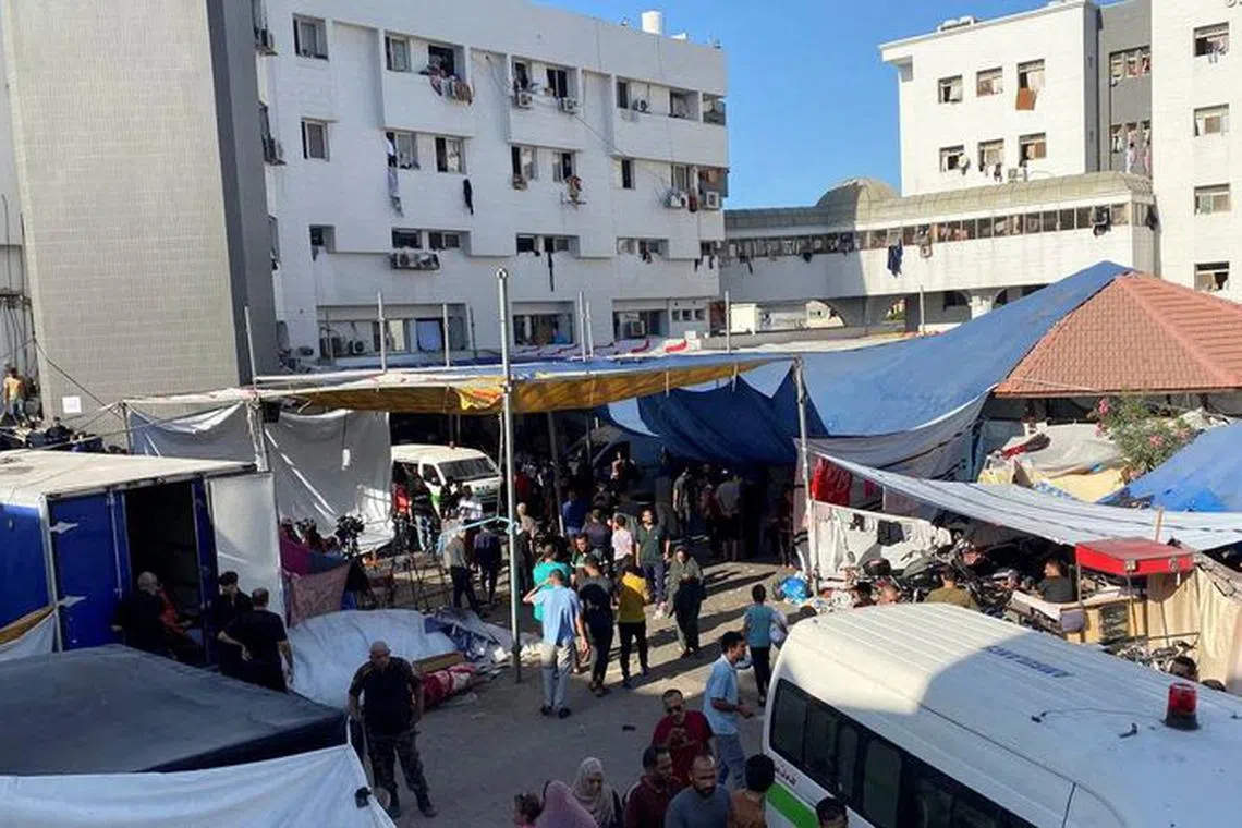 People, including Palestinian children, who fled their house due to Israeli strikes, gather at Al Shifa hospital where they shelter, amid the ongoing conflict between Israel and Palestinian Islamist group Hamas, in Gaza City November 7, 2023. REUTERS/Stringer/File Photo