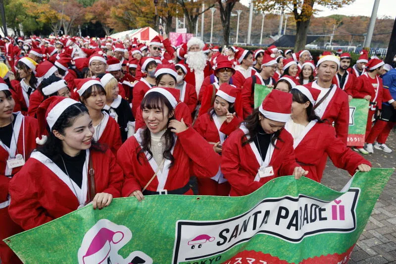 Participants at the 'Santa Parade' charity gift-giving event in Japan. Santa Claus may be traditionally a male figure but the heavy lifting in Christmas giving is done by women, says the writer. 