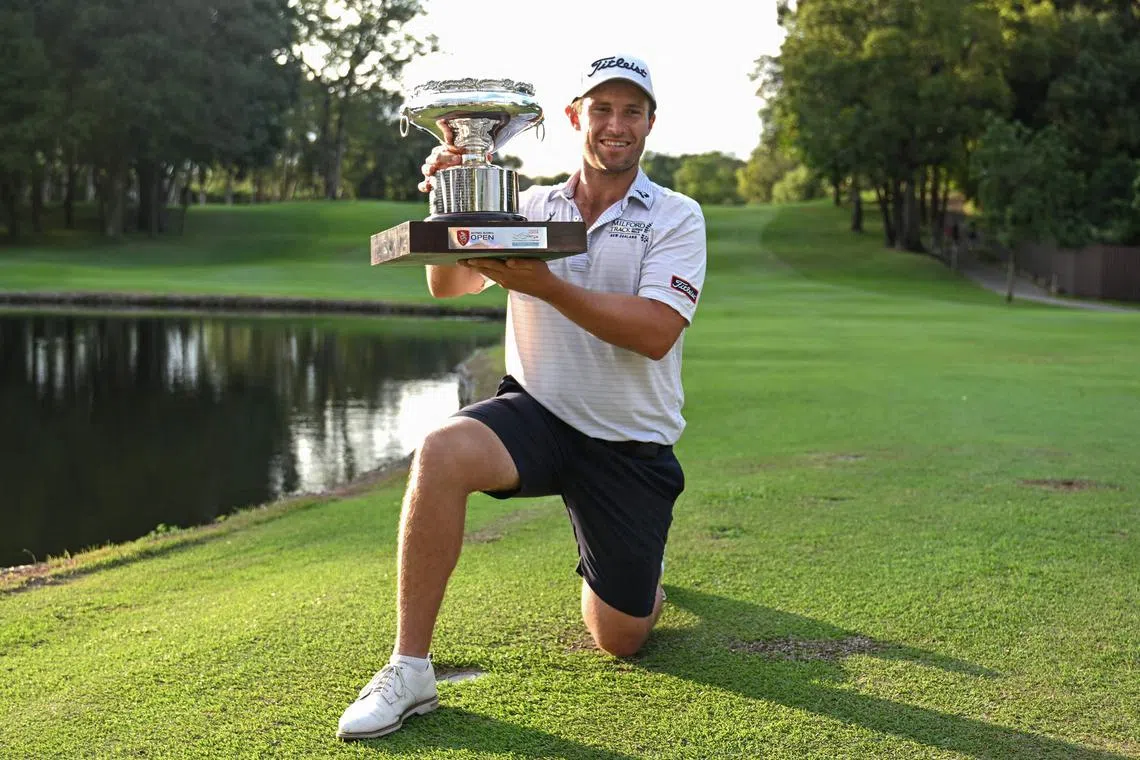 New Zealand's Ben Campbell celebrates with the winner's trophy after his victory on the final day of the Hong Kong Open.