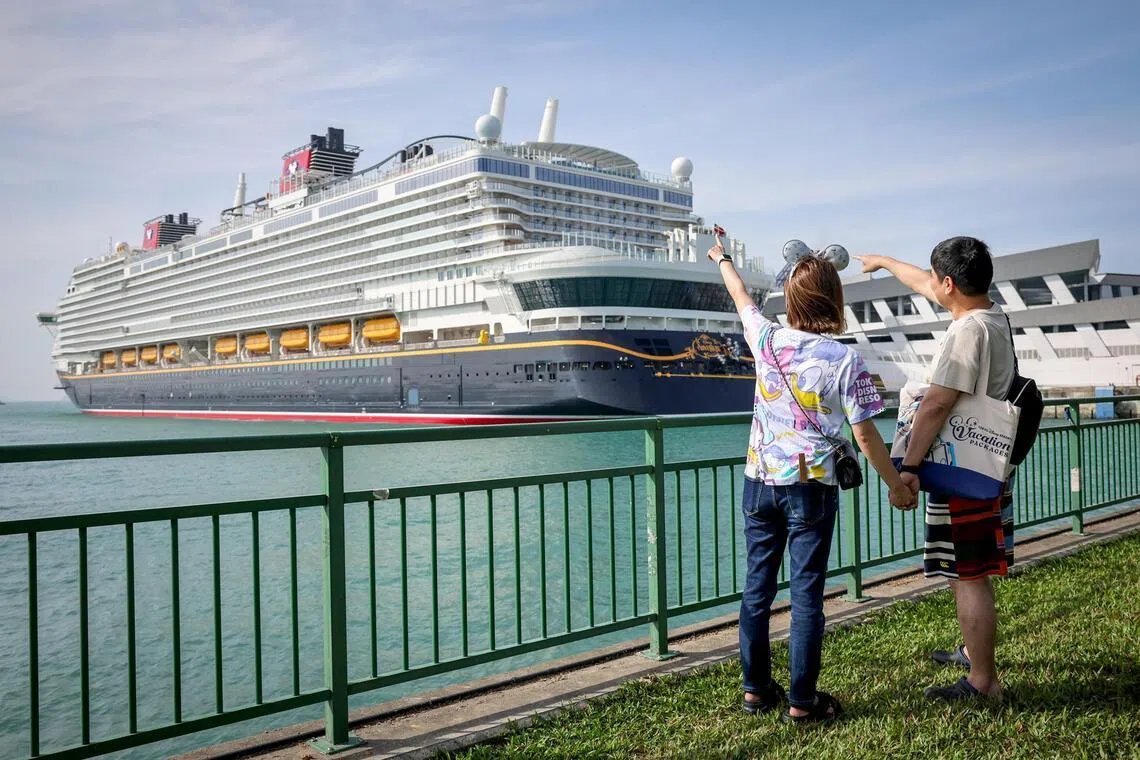 Two passengers pose for a photograph ahead of the Disney Adventure’s maiden voyage on March 10. The cruise will roll out a US$5 (S$6.40) delivery charge for in-room dining orders from June 4.