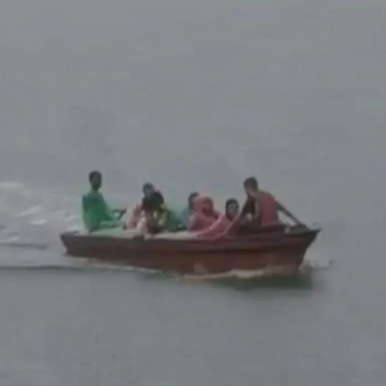 As the fast-moving boat turned a corner, it flipped over and capsized in the middle of the river.