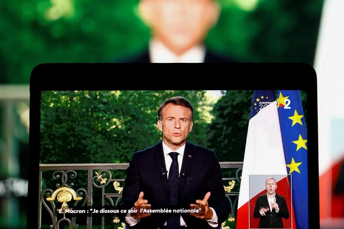 French President Emmanuel Macron appears on a screen as he delivers a speech following results after the polls closed in the European Parliament elections, in Paris on June 9. 