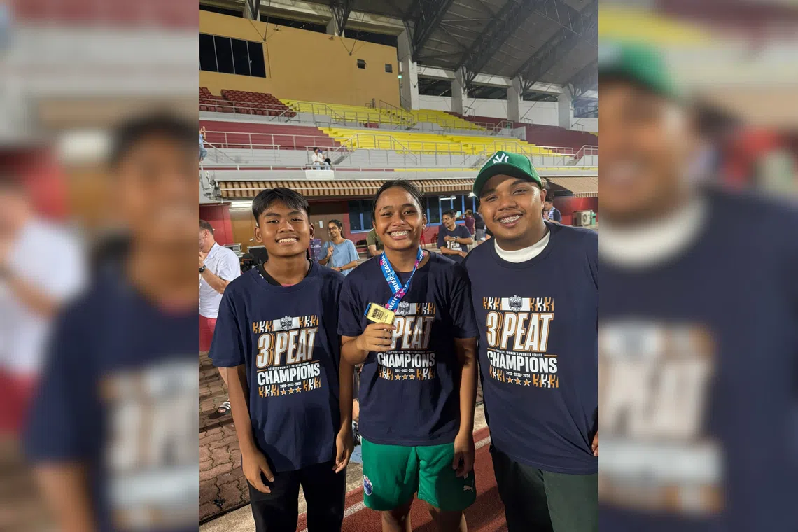 Singapore goalkeeper Izairida Shakira with her brothers Izaily Bryan and Izairi Owen (right) after she won the 2024 Women’s Premier League with the Lion City Sailors.