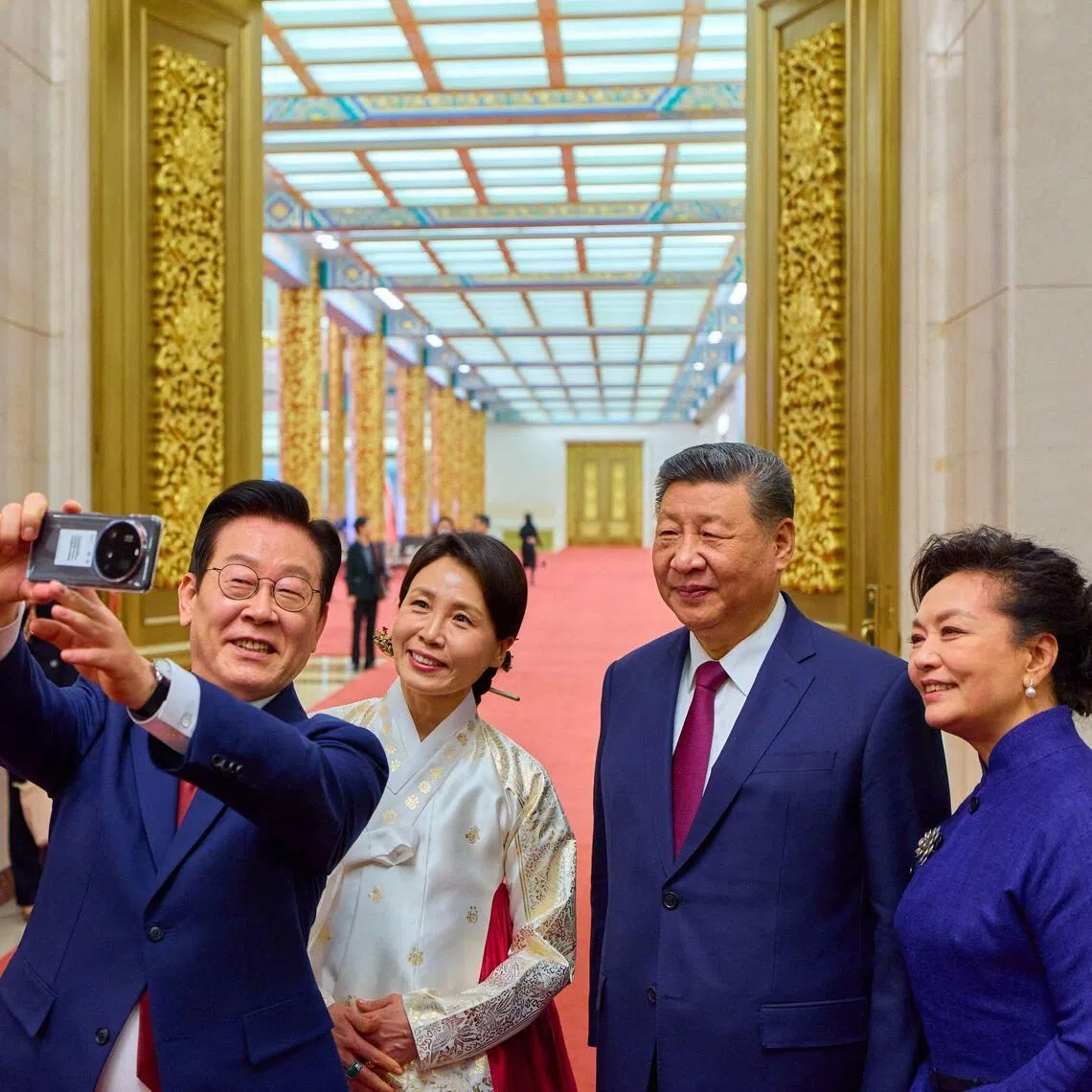 South Korea's President Lee Jae Myung (left) and his wife Kim Hea Kyung (2nd from left) take a selfie with China's President Xi Jinping (2nd from right) and his wife Peng Liyuan on Jan 5.